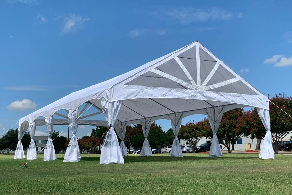 A large white tent in the middle of a field.