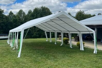 A large white tent in the middle of a field.