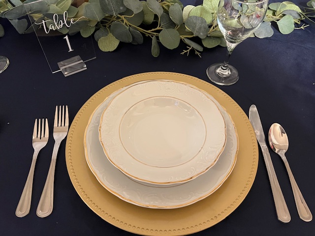 A table set with plates and silverware on top of it.